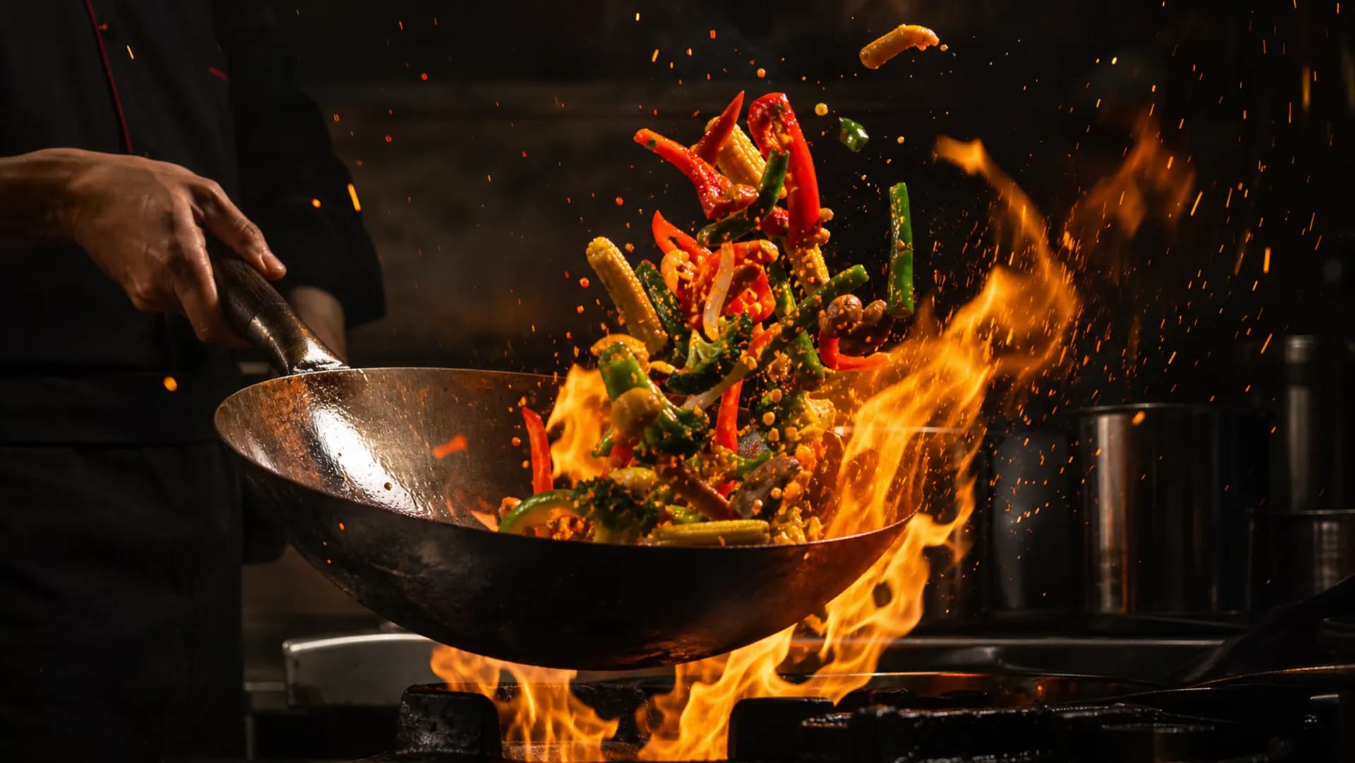 Vegetables and noodles tossed over a flaming wok